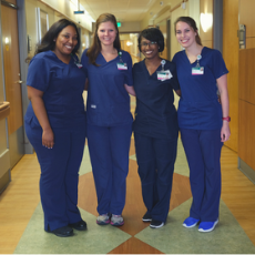 Group photo of nurses in blue scrubs