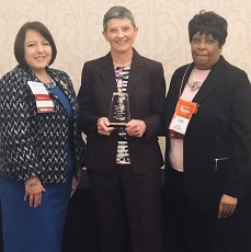 Terri Poe holding award, honored by Alabama State Nurses Association