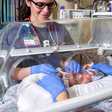 Female nurse attending to NICU baby