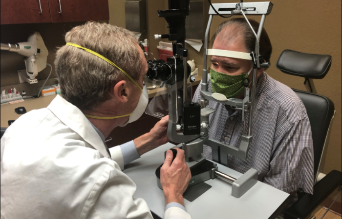 Ophthalmologist conducting an eye exam with a patient