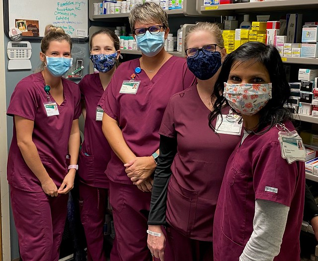 Group photo of UAB Pharmacy employees wearing maroon scrubs