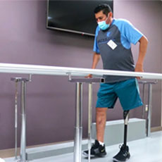 Patient Arnoldo Vasquez Hernandez practicing walking during a rehab session