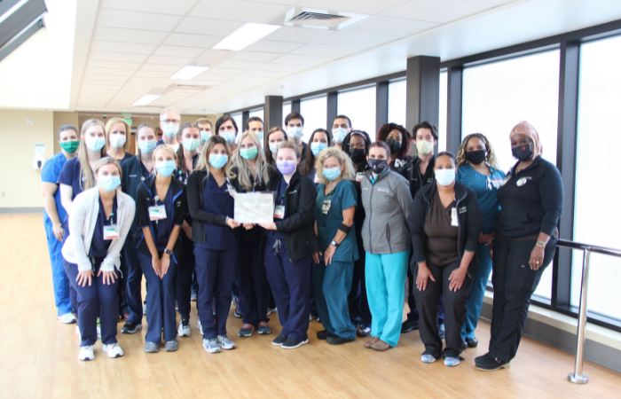 Group of nurses wearing blue scrubs with masks