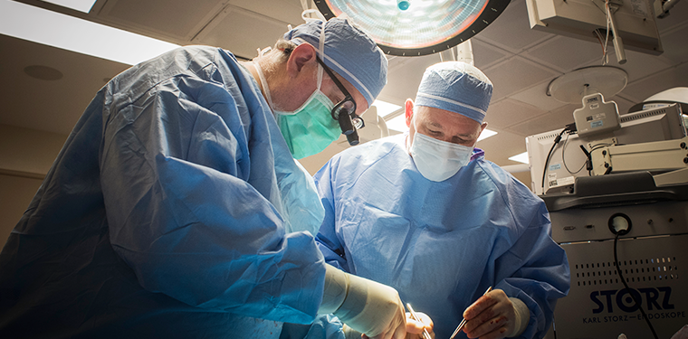two doctors performing a transplant related surgery