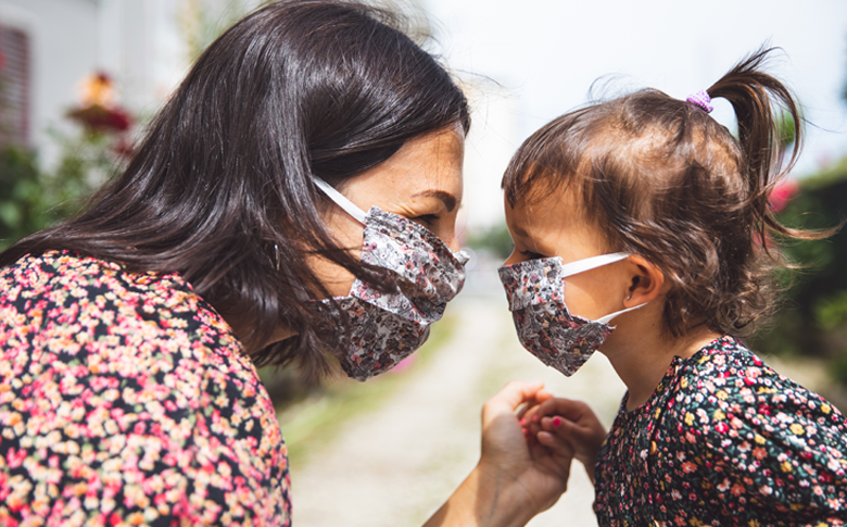 Mom and daughter wearing matching masks