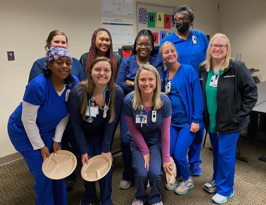 Group photo of nurses in blue scrubs for Nurses Week