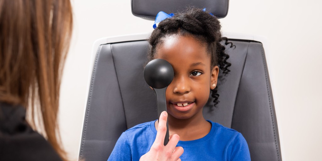 African American pediatric patient receiving an eye exam