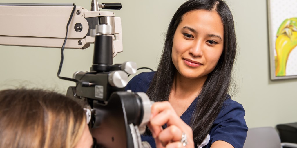 Asian American female conducting eye exam