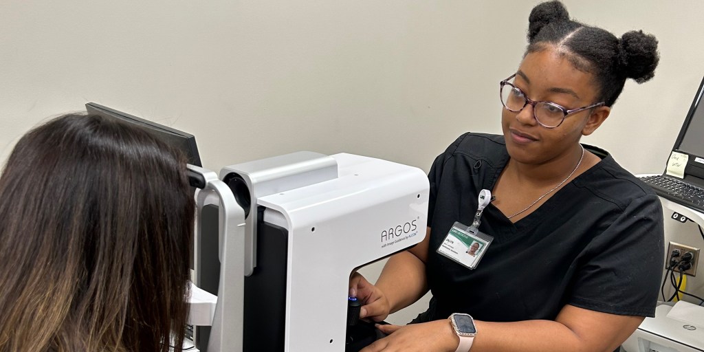 African American female conducting eye exam