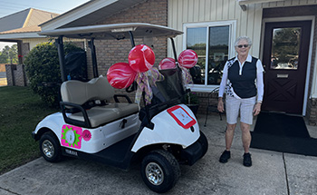 Sarah Hazen with decorated golf cart
