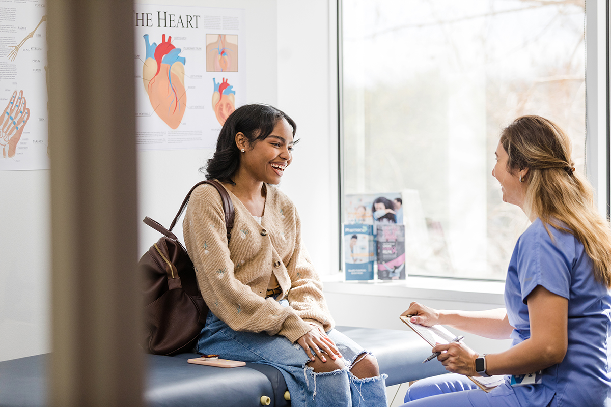 Young woman and female doctor laugh together