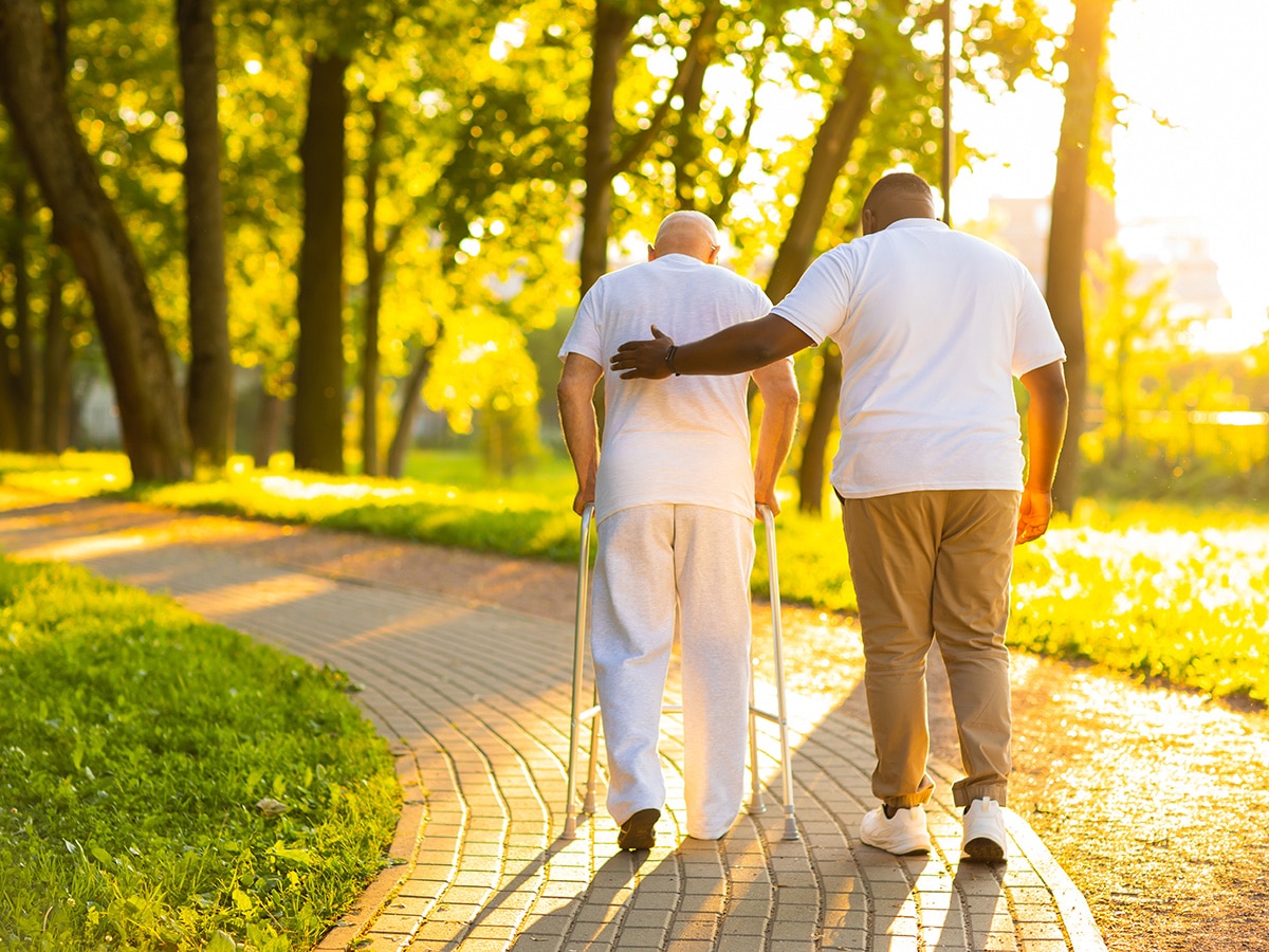 Man providing care for an elderly adult