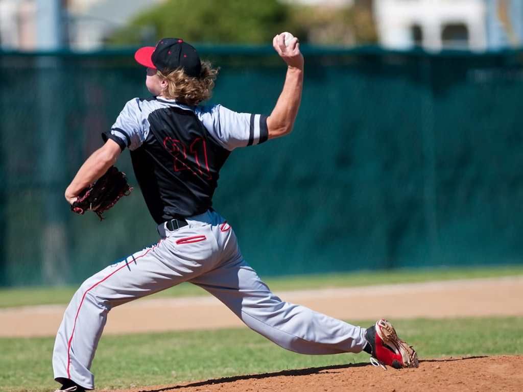 American teenage high school pitcher on the mound during a game.