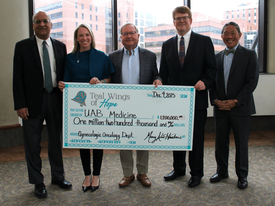 UAB Medicine staff holding a large check addressed to teal wings of hope