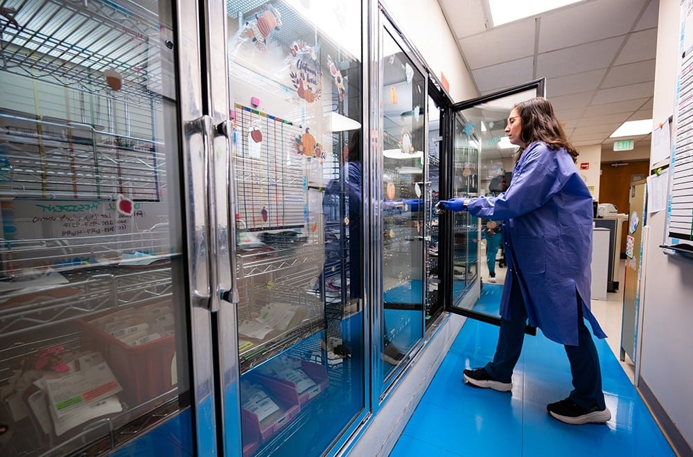 Medical Technologist Hallie Clark, M.S., MLS (ASCP), selects units of blood from the storage cooler in the Blood Bank.