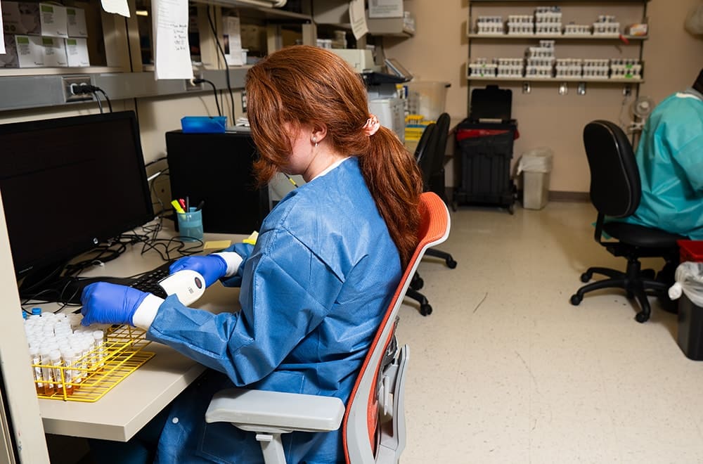 Medical Technologist Claudia Sheppard scans samples in the Infectious Diseases Laboratory.