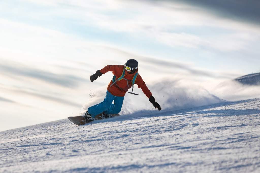 Snowboarder sliding down a snowy slope