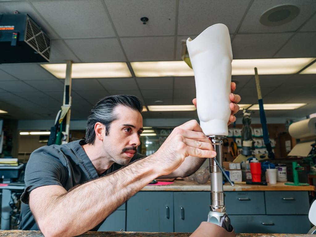 Man working on a 3-d printed prosthetic leg