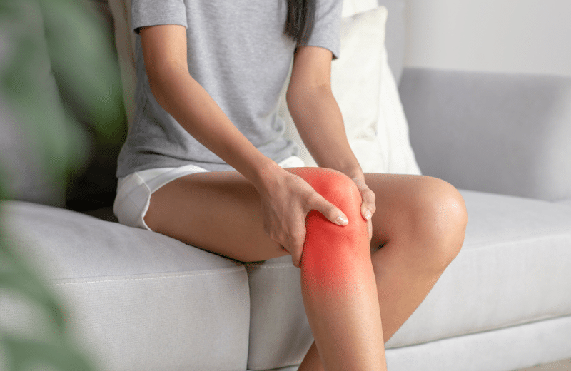 women holding her knee, with knee osteoarthritis