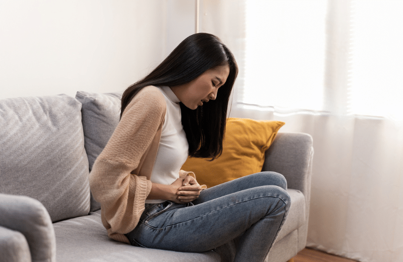 woman experiencing PCOS PMOS pain